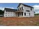 Exterior view of a two-story house under construction with a covered porch at 1916 King Mill Rd, Mcdonough, GA 30252
