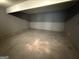 Unfinished basement space with concrete flooring and painted gray walls, ready to be transformed at 6372 Stonebridge Creek Ln, Lithonia, GA 30058
