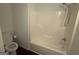 Bathroom featuring a standard bathtub with shower, a toilet, and neutral gray walls at 6372 Stonebridge Creek Ln, Lithonia, GA 30058
