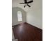 Bright bedroom features wood-look floors, neutral walls and arched window with lots of natural light at 6372 Stonebridge Creek Ln, Lithonia, GA 30058