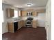 Functional kitchen with wooden cabinets, stainless steel appliances, and dark wood-look flooring at 6372 Stonebridge Creek Ln, Lithonia, GA 30058