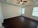 Spacious main bedroom featuring tray ceilings, neutral walls, and two large windows at 6372 Stonebridge Creek Ln, Lithonia, GA 30058