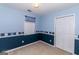 Cozy bedroom featuring blue walls, light carpet, and a double door closet at 421 Old Ivy Path, Mcdonough, GA 30253
