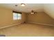 Spacious bonus room with neutral carpet, ceiling fan, and dormer window at 421 Old Ivy Path, Mcdonough, GA 30253