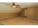 Expansive bonus room with ceiling fan and neutral carpet at 421 Old Ivy Path, Mcdonough, GA 30253