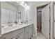 Bright bathroom featuring a double vanity with gray cabinets and a separate water closet at 4760 Highside Way, Smyrna, GA 30082