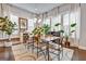 Elegant dining room with a modern chandelier, natural light from large windows, and stylish decor at 4760 Highside Way, Smyrna, GA 30082
