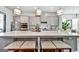 Gourmet kitchen with gray cabinets, large island with bar seating, stainless steel appliances, and modern pendant lights at 4760 Highside Way, Smyrna, GA 30082