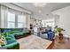 Open-concept living area with modern decor, hardwood floors, seamlessly connecting living, dining, and kitchen at 4760 Highside Way, Smyrna, GA 30082