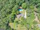 Stunning aerial view of a secluded home with a sparkling pool surrounded by lush greenery and mature trees at 4820 Yeager Rd, Douglasville, GA 30135