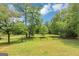 Expansive, well-maintained backyard with mature trees and a fenced area at 4820 Yeager Rd, Douglasville, GA 30135