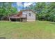Back exterior view of home with a private deck overlooking the expansive backyard at 4820 Yeager Rd, Douglasville, GA 30135