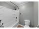 A bathroom featuring neutral walls, tiled floors, a shower and a toilet at 4820 Yeager Rd, Douglasville, GA 30135