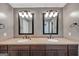 Double vanity in the bathroom with dual mirrors and lighting offers style and practicality at 4820 Yeager Rd, Douglasville, GA 30135