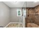 Elegant bathroom featuring a tiled shower with glass partition, combining modern design with comfort at 4820 Yeager Rd, Douglasville, GA 30135
