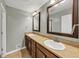 A bathroom features a double sink vanity and a tiled floor at 4820 Yeager Rd, Douglasville, GA 30135