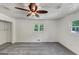 A light filled bedroom featuring neutral walls and floors, and ceiling fan at 4820 Yeager Rd, Douglasville, GA 30135