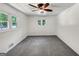 A light filled bedroom with neutral walls and floors and ceiling fan at 4820 Yeager Rd, Douglasville, GA 30135