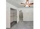 A bedroom with neutral walls and floors, closet, and a ceiling fan with lights at 4820 Yeager Rd, Douglasville, GA 30135