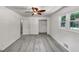 A bedroom with neutral walls and floors, closet, a ceiling fan and a sunlit window at 4820 Yeager Rd, Douglasville, GA 30135