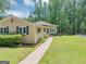 Landscaped front yard with a walkway leading to the home, blending comfort and charm at 4820 Yeager Rd, Douglasville, GA 30135
