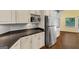 Close up of kitchen countertops and stainless steel refrigerator and microwave at 4820 Yeager Rd, Douglasville, GA 30135