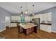 Kitchen with hardwood floors and a center island with cooktop, pendant lights, and stainless steel appliances at 4820 Yeager Rd, Douglasville, GA 30135
