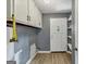 Functional laundry room with overhead cabinets, providing ample storage and convenience at 4820 Yeager Rd, Douglasville, GA 30135