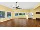 Living area with hardwood floors, ceiling fan, and large windows showcasing the backyard pool at 4820 Yeager Rd, Douglasville, GA 30135
