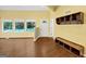 Bright living area with hardwood floors, large windows offering backyard pool views, and built-in shelving at 4820 Yeager Rd, Douglasville, GA 30135