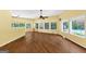 Spacious living room with hardwood floors, ceiling fan, and large windows overlooking the pool and backyard at 4820 Yeager Rd, Douglasville, GA 30135