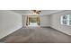 Expansive living room with plush carpeting and large windows, creating a bright and inviting space at 4820 Yeager Rd, Douglasville, GA 30135