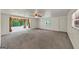 Spacious living room with carpet flooring, natural light, and a ceiling fan enhancing comfort at 4820 Yeager Rd, Douglasville, GA 30135