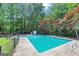 Large inground pool with fenced perimeter and surrounding wooded area for privacy at 4820 Yeager Rd, Douglasville, GA 30135