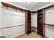 Well-organized walk-in closet with wooden shelves and custom storage system at 4820 Yeager Rd, Douglasville, GA 30135