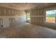 Unfinished bedroom features blank walls, two bright windows, and rough flooring at 1936 King Mill Rd, Mcdonough, GA 30252