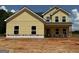 New construction featuring yellow siding, black roof, white trim, and bright windows at 1936 King Mill Rd, Mcdonough, GA 30252