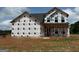 New construction home featuring architectural details awaiting finishing touches, including large windows at 1936 King Mill Rd, Mcdonough, GA 30252