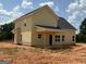 Exterior of home with yellow siding and a covered porch at 1936 King Mill Rd, Mcdonough, GA 30252
