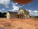 New construction home with yellow siding and a dark roof at 1936 King Mill Rd, Mcdonough, GA 30252