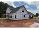 View of house during construction showing back and side with installed windows at 1936 King Mill Rd, Mcdonough, GA 30252