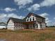 A two-story home under construction, showcasing the roof and window placement at 1936 King Mill Rd, Mcdonough, GA 30252