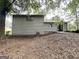 View of the backyard with a concrete patio and fenced in area, perfect for relaxing outdoors at 3879 Mcgill Ln, Decatur, GA 30034