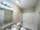 Clean bathroom with a granite vanity top, a large mirror, and a shower over the bathtub at 3879 Mcgill Ln, Decatur, GA 30034