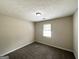 Simple bedroom featuring plush carpet, neutral paint, and natural light from a window at 3879 Mcgill Ln, Decatur, GA 30034