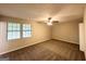 Spacious bedroom with neutral colors, carpeted floor, ceiling fan, and natural light from the windows at 3879 Mcgill Ln, Decatur, GA 30034