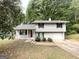 Inviting split-level home with a cozy front porch and a vibrant red front door at 3879 Mcgill Ln, Decatur, GA 30034