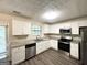 Modern kitchen featuring granite countertops, stainless steel appliances, and white cabinets at 3879 Mcgill Ln, Decatur, GA 30034