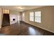 Open-concept living area showcasing wood floors, staircase, and view of the fireplace at 3879 Mcgill Ln, Decatur, GA 30034