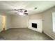 Cozy living room with carpet, a ceiling fan, and a traditional fireplace at 3879 Mcgill Ln, Decatur, GA 30034